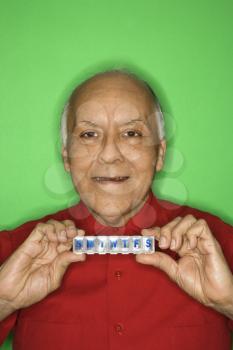 Royalty Free Photo of a Man Holding a Pill Organizer