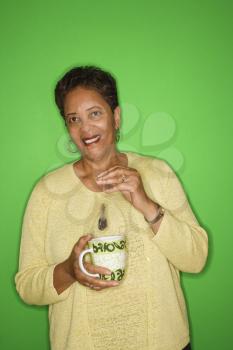 Royalty Free Photo of a Woman Dipping a Tea Bag in a Mug