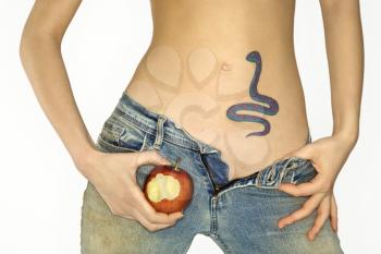 Royalty Free Photo of a Woman With a Snake Tattoo Holding an Apple