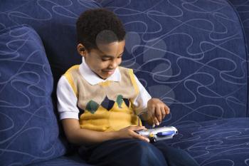Royalty Free Photo of a Young Boy Playing a Video Game