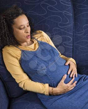 Royalty Free Photo of a Portrait of Pregnant Woman With Her Hands on Her Stomach