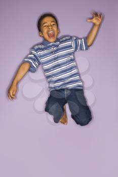 Royalty Free Photo of a Young Boy Jumping