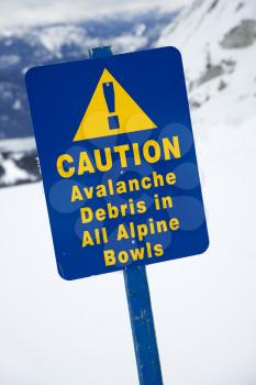 Royalty Free Photo of a Snow Ski Resort Caution Sign on a Mountain Side