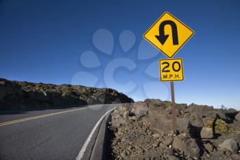 Royalty Free Photo of a Road and Curve in Road Sign in Haleakala National Park, Maui, Hawaii
