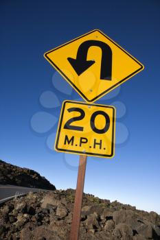 Royalty Free Photo of a Road and Curve in Road Sign in Haleakala National Park, Maui, Hawaii