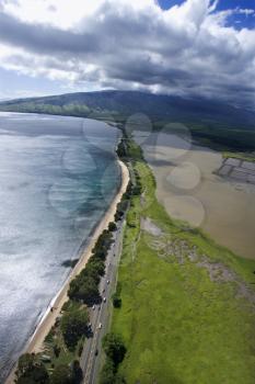 Royalty Free Photo of an Aerial of a Road Following Maui, Hawaii Coastline With Beach