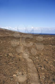 Royalty Free Photo of a Pathway Leading Through a Rocky Terrain in Maui, Hawaii
