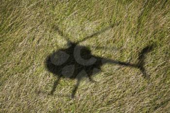 Royalty Free Photo of a Helicopter shadow Over a Green Grassy Field in Maui, Hawaii
