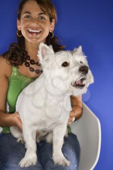 Royalty Free Photo of a Woman Holding a White Terrier Dog