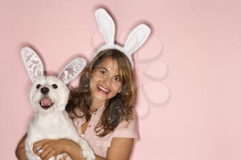 Royalty Free Photo of a Woman and Her Dog Wearing Bunny Ears