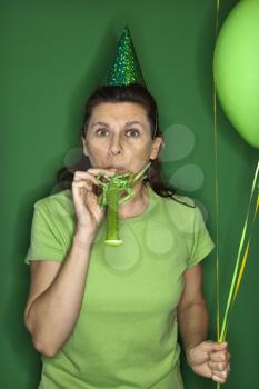 Royalty Free Photo of a Woman Wearing a Party Hat and Party Blower