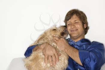 Royalty Free Photo of a Male With a Fluffy Brown Dog