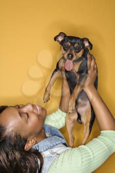 Royalty Free Photo of a Woman Holding a Miniature Pinscher Dog