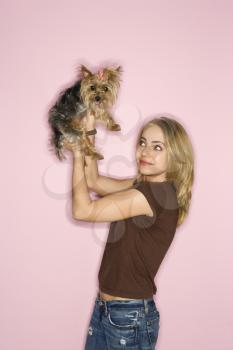 Royalty Free Photo of a Woman Holding Up a Yorkshire Terrier Dog