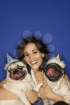 Royalty Free Photo of a Female Holding Two Pug Dogs