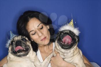 Royalty Free Photo of a Woman Holding Two Pug Dogs