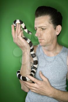 Royalty Free Photo of a Man Holding a California Kingsnake