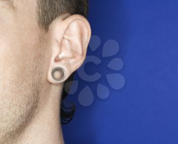 Young adult Caucasian male pierced ear.