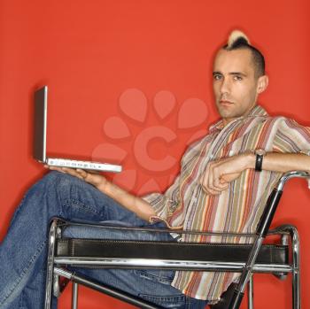 Royalty Free Photo of a Man Holding a Laptop
