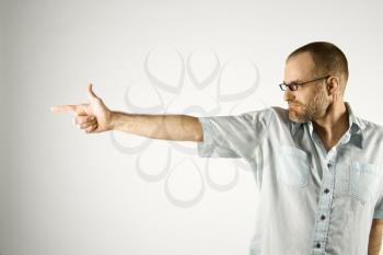 Royalty Free Photo of a Man Holding His Hand Out Like a Gun