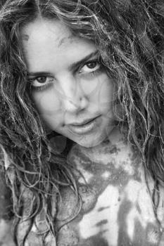 Royalty Free Photo of a Young Woman Covered in Mud Smiling