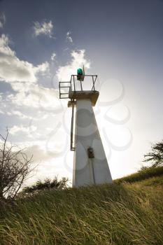 Royalty Free Photo of a Lighthouse in a Grassy Field in Maui Hawaii