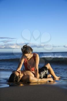 Royalty Free Photo of a Young Couple Frolicking on the Beach