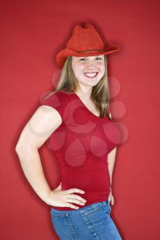 Royalty Free Photo of a Woman Wearing a Red Cowboy Hat