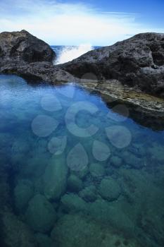 Royalty Free Photo of a Tidal Pool With Waves Crashing on Rocks in Maui, Hawaii, USA