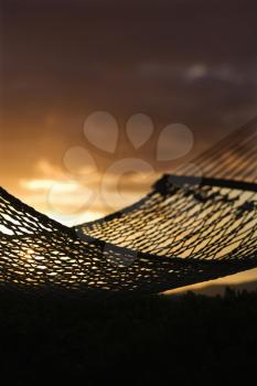 Royalty Free Photo of a Close-up of a Hammock Silhouette against an Ocean Sunset in Maui, Hawaii, USA