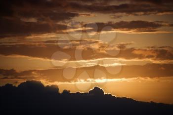 Royalty Free Photo of a Golden Sunset With Glowing Cloud Edges in Maui, Hawaii, USA