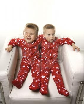 Royalty Free Photo of Twin Boys Sitting Together