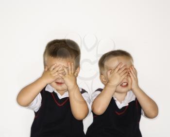Royalty Free Photo of Twin Boys Covering Their Eyes