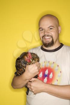 Royalty Free Photo of a Man Holding a Golden Laced Wyandotte Chicken
