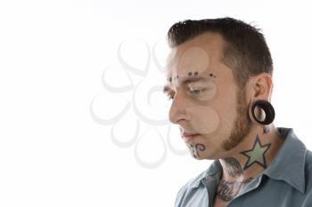 Royalty Free Photo of a Man With Tattoos and Piercings