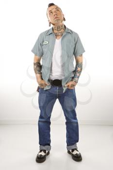 Royalty Free Photo of a Tattooed Man Looking Up