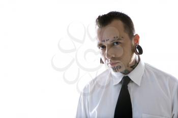 Royalty Free Photo of a Man With Tattoos and Piercings Wearing a Necktie