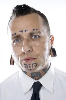 Royalty Free Photo of A Man With Tattoos and Piercings Wearing a Necktie