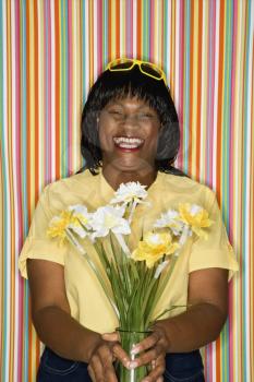 Royalty Free Photo of a Woman Laughing Holding Flowers