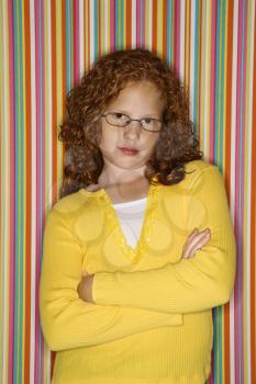 Royalty Free Photo of a Girl With Her Arms Crossed Looking Serious