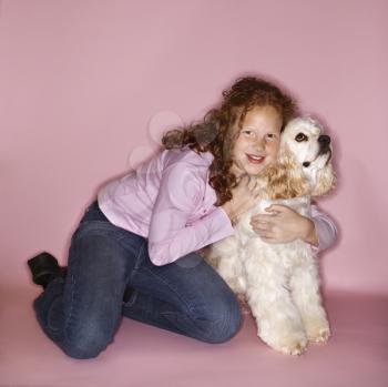 Royalty Free Photo of a Little Girl Hugging a Cocker Spaniel 