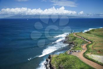 Royalty Free Photo of an Aerial View of a Coastline With Surfers and Parked Cars on Maui, Hawaii