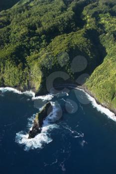 Aerial view of Maui, Hawaii coast with rock jutting out of Pacific ocean.