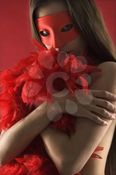 Royalty Free Photo of a Partially Nude Caucasian Woman Wearing a Mask and Boa