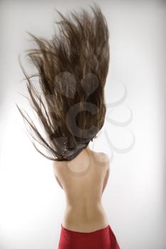Topless Caucasian woman swinging her hair.