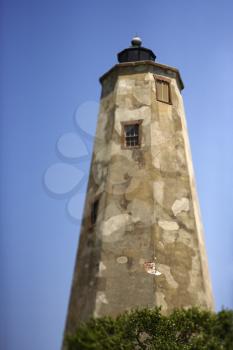Royalty Free Photo of a Worn and Weathered Lighthouse on Bald Head Island, North Carolina