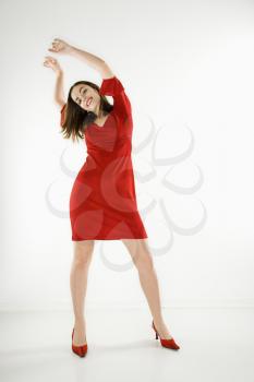Royalty Free Photo of a Woman Wearing a Red Dress Smiling