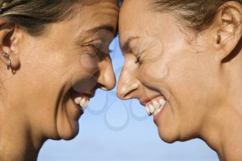 Royalty Free Photo of Women With Heads Together Smiling