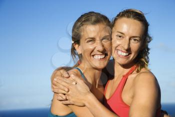 Royalty Free Photo of Women Hugging Each Other and Smiling