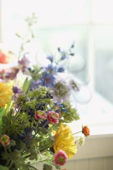 Royalty Free Photo of a Flower Arrangement in Front of a Window